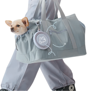 Kleiner Hund schaut aus grauer Reisetasche mit grauem, gefaltetem Silikonnapf an der Seite befestigt.